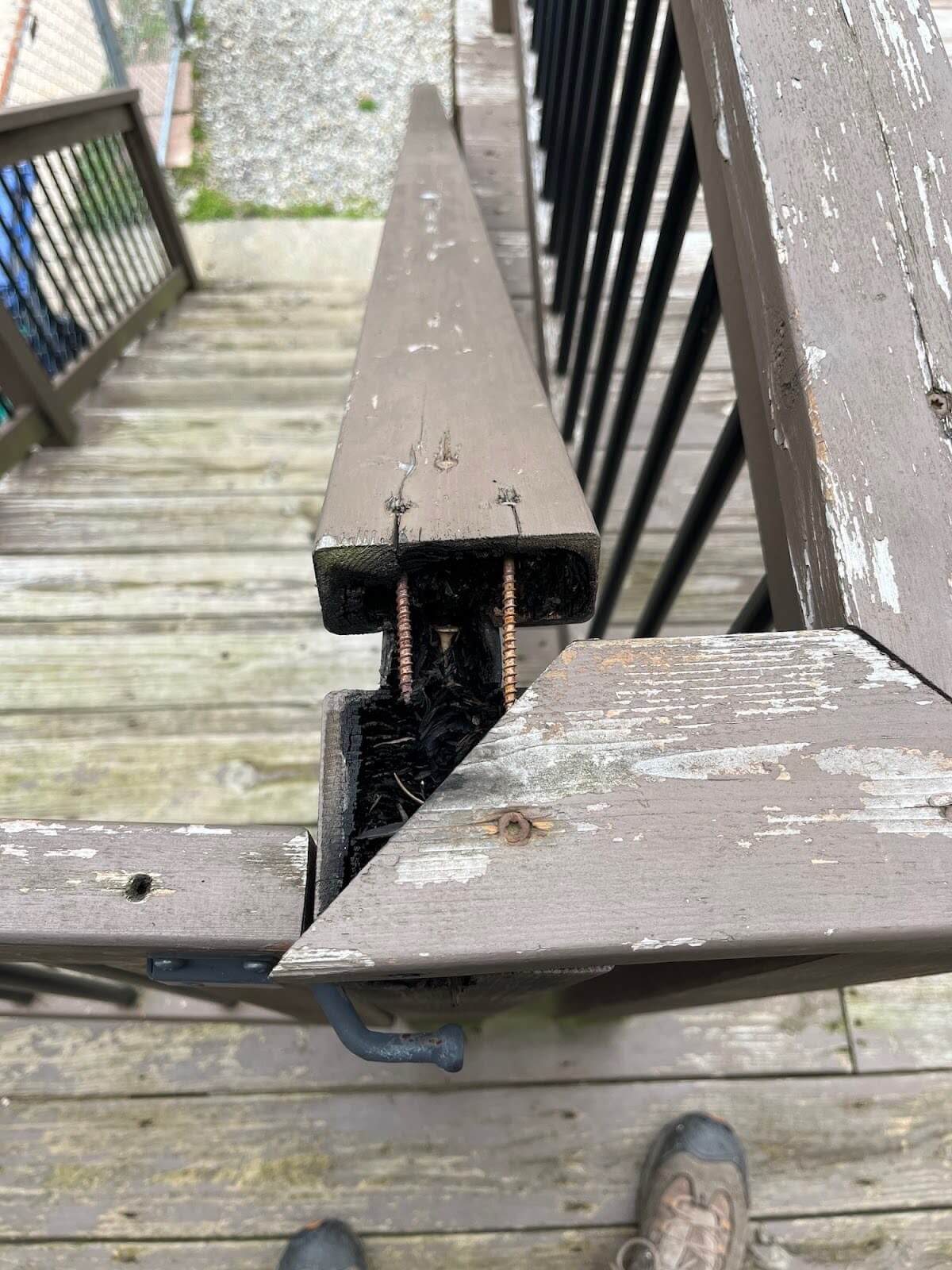 A damaged wooden staircase handrail