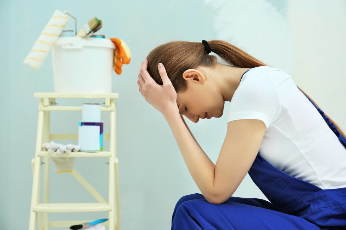 A woman holding her head down looking disappointed.