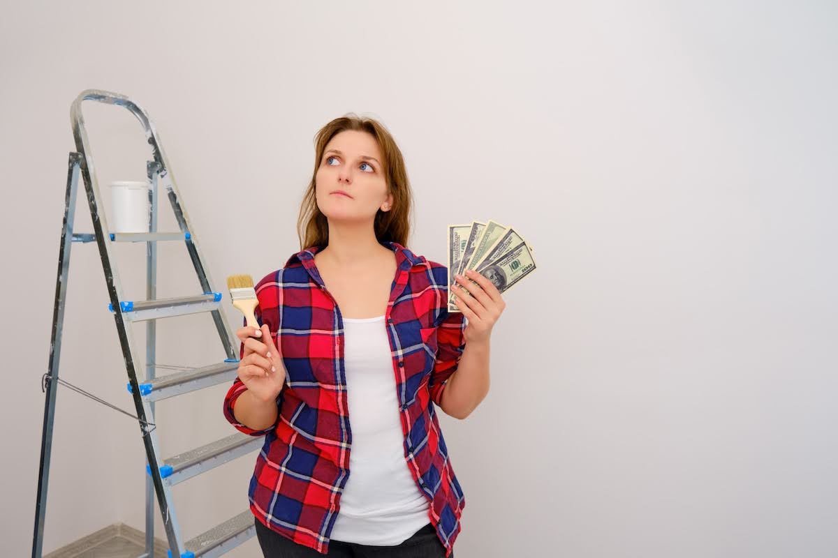 A woman holding a paint brush